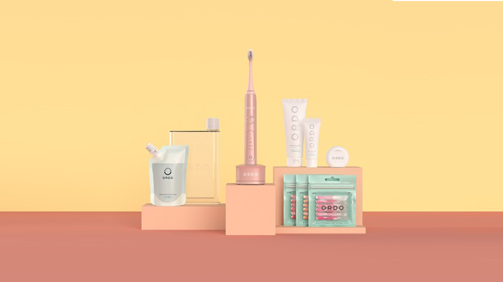 Ordo electric toothbrush, toothpaste and other oral health care items sitting on a platform